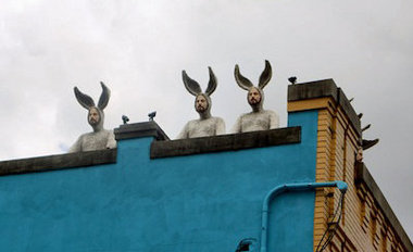 Three of Alex Podesta's 'bunny men' gaze down on Oretha Castle Haley Boulevard from their rooftop perch. (Photo: Linda Friedman)