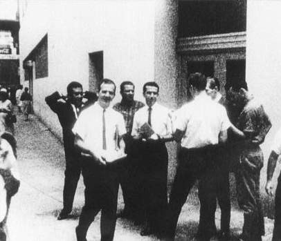 Lee Harvey Oswald distributing Fair Play for Cuba leaflets outside the original ITM, August 16, 1963. (Photo by WDSU-TV cameraman Johann Rush)