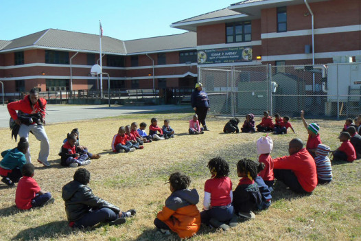 A group of students plays duck duck goose outside of Playworks.