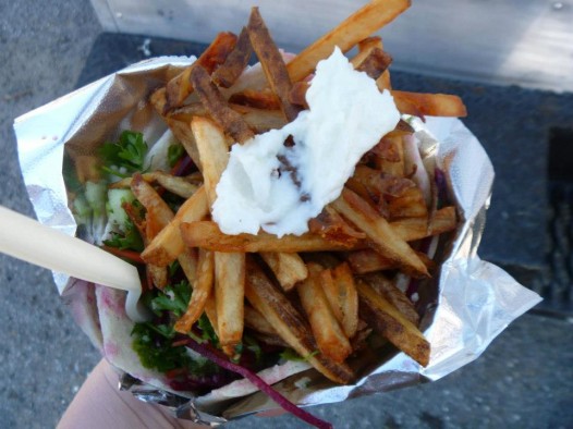The Fat Falafel tops their fries with dollops of toum. 