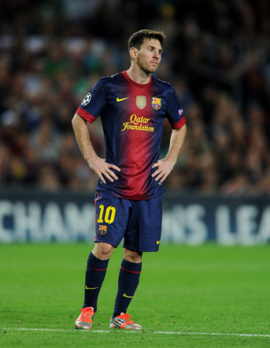 The Qatar Foundation logo is prominently displayed across the jersey of FC Barcelona player Lionel Messi 