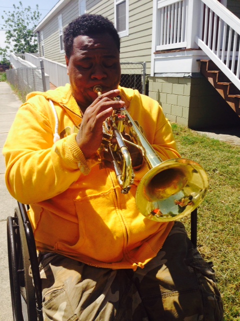 Terrell Batiste plays his trumpet in front of his new Habitat for Humanity house in the Upper 9th Ward.