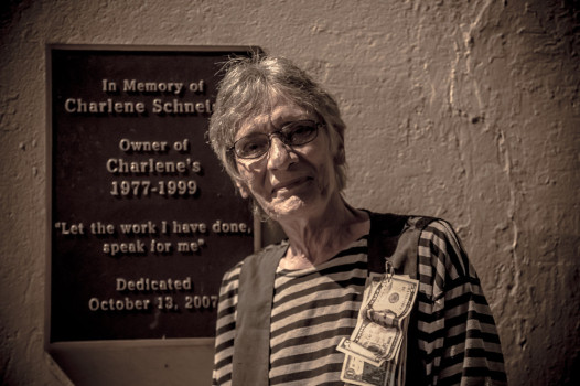 Dianne Schneider next to a plaque honoring her sister, Charlene. Credit: Melisa Cardona