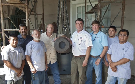 Members of Abry Brothers, founded in 1840, operating shoring contractor ----- include (from left to right) Joel Argueta, Foreman Melvin Erazo, Project Manager John Abry, Operations Manager Scott Wolf, President and owner Greg Abry, Anthony Marciante, Freddie Alvarado, and Edwin Perez. Greg Abry is part of the sixth generation of the Abry family. Abry Brothers ----- which generously donated its services to the LSM’s replica carriage project ----- erected two 20,000-pound-capacity shoring towers, spanned these with two 250-pound cross beams, and gently lowered the massive Spanish cannon onto the carriage’s bed via two three-ton chain hoists (one attached to a sling around the front of the cannon, and a second attached to a sling around the rear of the cannon).