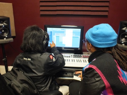 AF THE NAYSAYER works with a student at Upbeat Academy