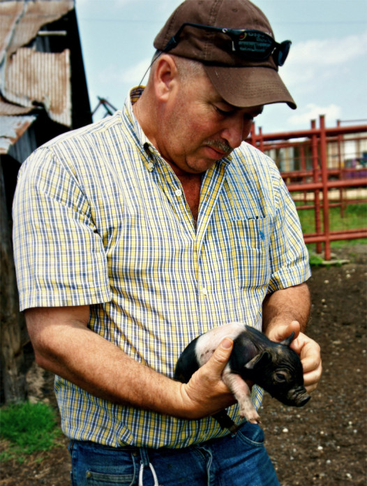 Farmer Ryals with a piglet (Photo: Ashley Locklear)