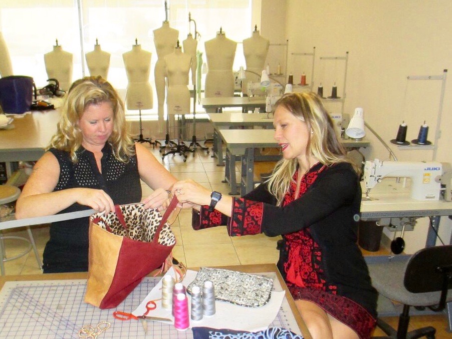 April Clark and Alison Parker measure samples for their leather handbag design class.