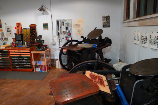 Baskerville's three century-old Chandler & Price platen presses, also called "clamshells" because of how they open and close: the table-top press operates with a lever, the press in the foreground runs off a treadle, and the large press in the corner will be motorized.