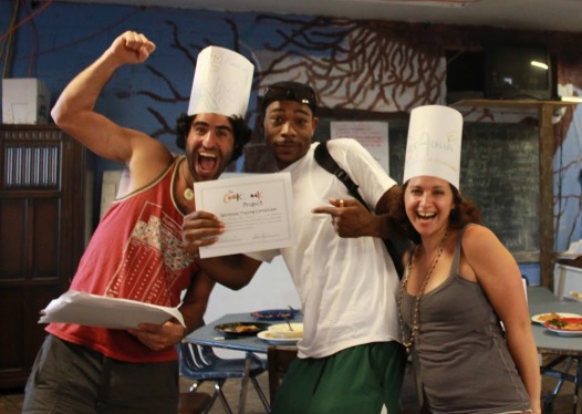 Adam Aronovitz, left, and Alissa Bilfield, right, celebrate with a happy workshop graduate.