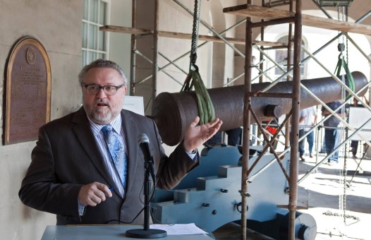 At the arcade of the historic Cabildo, Mark Tullos, Jr., Director of the Louisiana State Museum system, welcome guests to the dedication and press conference for the reconstructed naval carriage that now cradles the LSM’s Spanish cannon. This storied gun - which measures 10.5-feet long and weighs an impressive 5,789 pounds - was originally mounted at Fort St. John (also known as Spanish Fort) near the New Orleans Lakefront and then was used by American defenders at the Battle of New Orleans in Chalmette (1815) and also against Admiral David Farragut’s Union fleet (1862). The LSM acquired the cannon in 1908.