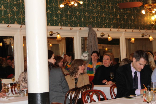 Christine Vinson (center) in a Mardi Gras-colored scarf at the Galatoire Foundation Mardi Gras Table Auction. (Photo:Caitlin Switzer/The Ehrhardt Group)