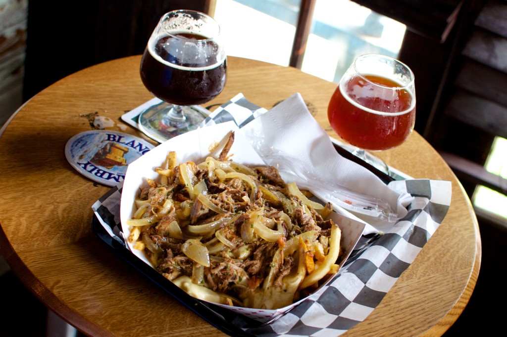 "Dump truck fries" at The Avenue Pub. There are potatoes under there. Somewhere.