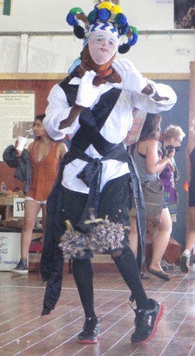 A Charikanari dancer, dressed in Western garb - long-sleeved shirt, white gloves, black knees socks and wire mesh mask with European features, did a Charlie Chaplin-esque dance, mimicking British colonialists. 